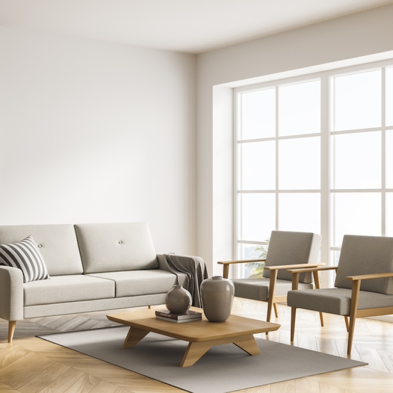 Light beige living room interior with sofa, two armchairs, coffee tables, pendant light, cabinet with open shelves, panoramic window and parquet floor. Concept of modern interior design. 3d rendering